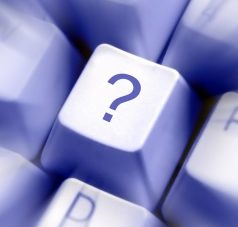 A keyboard key with a question mark which hints at the 5 Questions And Their Answers.