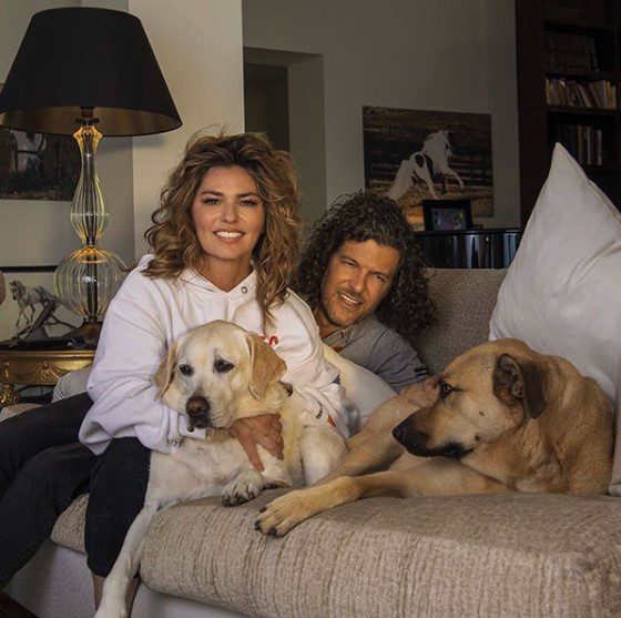 Instagram post from Shania Twain with her two dogs and hubby