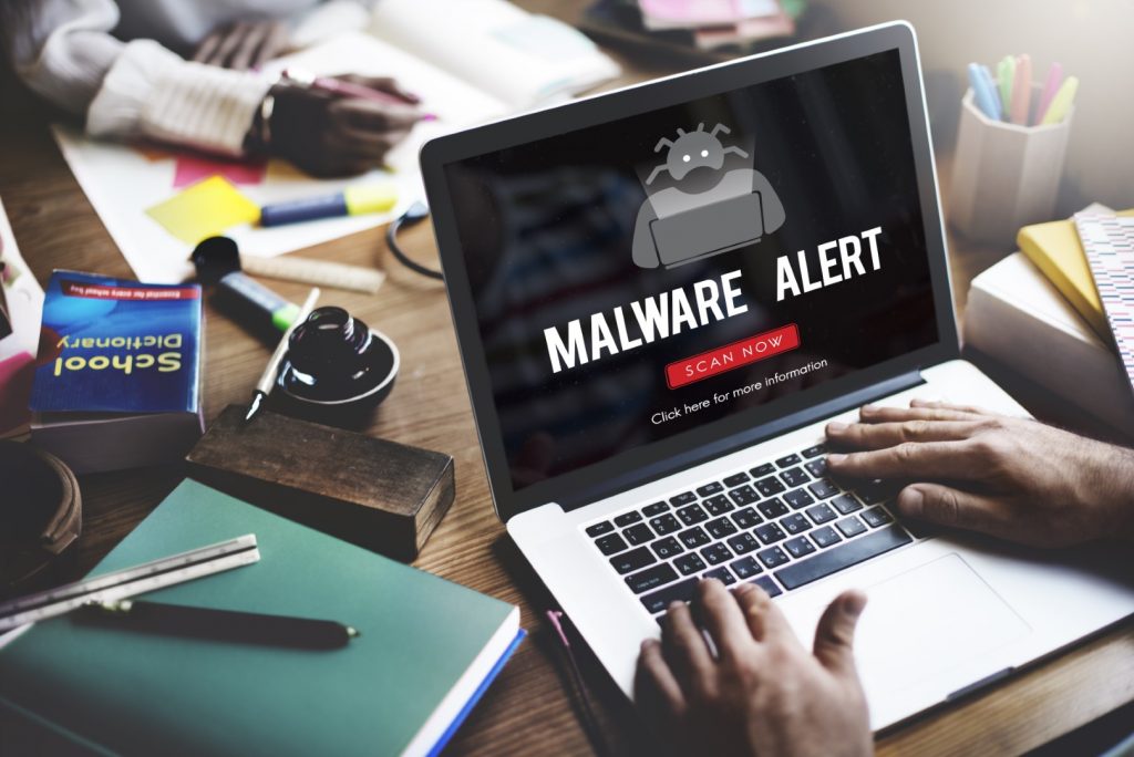A laptop with a malware alert like you would get if you download Windows 11 and malware